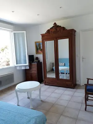 a living room with a mirror and a table at Maisonnette 2 minutes pied plage in Grosseto-Prugna
