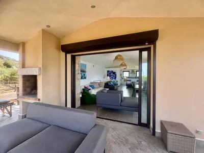 a living room with a blue couch and a living room at Villa d'exception à Tizzano in Sartène