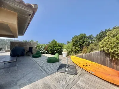 a yellow kayak sitting on a deck next to a fence at Villa d'exception à Tizzano in Sartène