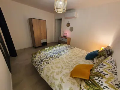a bedroom with a bed and a dresser in it at T2 Yucca LCP - Beautiful 48 m2 2-room, 17 m2 terrace, new, air conditioning in Grosseto-Prugna