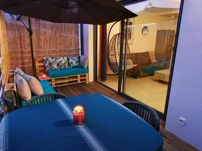 a blue table with a candle on top of a room at T2 Yucca LCP - Beautiful 48 m2 2-room, 17 m2 terrace, new, air conditioning in Grosseto-Prugna
