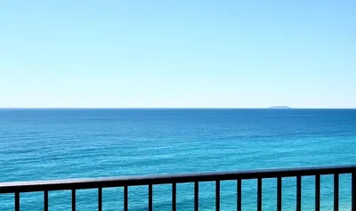 a view of the ocean from a balcony at VUE MER EXCEPTIONNELLE !! Bien calme et lumineux sur la prestigieuse route des Sanguinaires à Ajaccio in Ajaccio