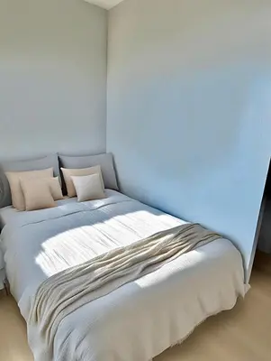 a bed with two pillows on it in a room at VUE MER EXCEPTIONNELLE !! Bien calme et lumineux sur la prestigieuse route des Sanguinaires à Ajaccio in Ajaccio