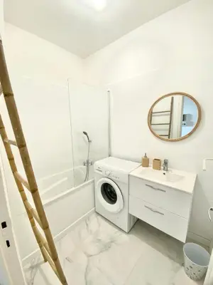 a white bathroom with a washing machine and a sink at VUE MER EXCEPTIONNELLE !! Bien calme et lumineux sur la prestigieuse route des Sanguinaires à Ajaccio in Ajaccio