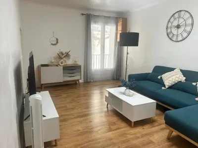 a living room with a blue couch and a tv at Appartement Citadelle in Bonifacio