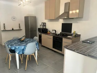 a kitchen with a table and a kitchen with a stove at Appartement Citadelle in Bonifacio