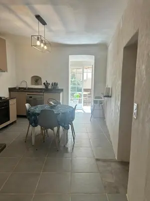 a kitchen and dining room with a table and chairs at Appartement Citadelle in Bonifacio