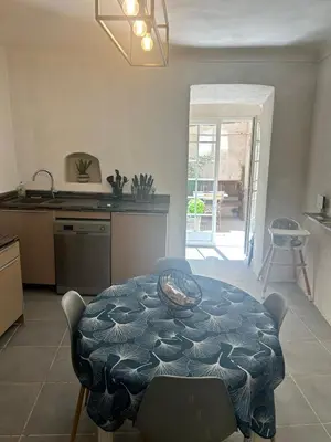 a kitchen with a table in the middle of a room at Appartement Citadelle in Bonifacio