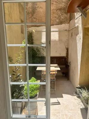 a window view of a patio with a table at Appartement Citadelle in Bonifacio