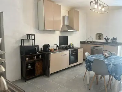 a kitchen with a table and a stove top oven at Appartement Citadelle in Bonifacio