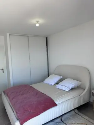 a bed with two pillows on it in a room at Beautiful Appartment Les terrasses de Torretta room sea view Ajaccio in Ajaccio