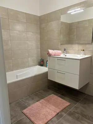 a bathroom with a tub and a sink and a bath tub at Beautiful Appartment Les terrasses de Torretta room sea view Ajaccio in Ajaccio