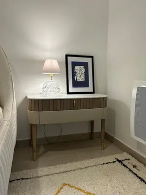 a table with a lamp on it next to a bed at Beautiful Appartment Les terrasses de Torretta room sea view Ajaccio in Ajaccio
