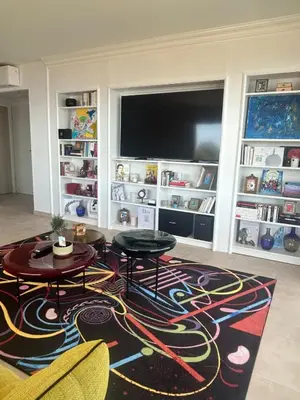 a living room with two tables and a flat screen tv at Beautiful Appartment Les terrasses de Torretta room sea view Ajaccio in Ajaccio