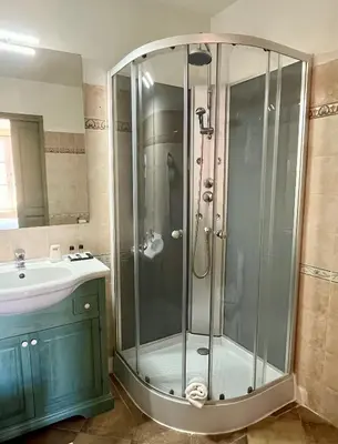 a bathroom with a shower and a sink at Colomba Hôtel Centre-Ville Historique in Bonifacio