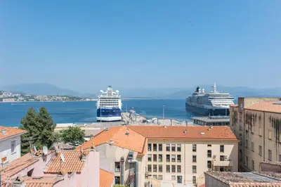 two cruise ships docked in a harbor with buildings at T2 40m2 climatisé centre ville FESCH in Ajaccio