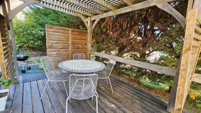 a table and chairs on a wooden deck at Location de charme au coeur de la Corse - Piscine privative - calme - nature in San-Lorenzo