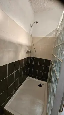 a bathroom with a bath tub with a shower at Location de charme au coeur de la Corse - Piscine privative - calme - nature in San-Lorenzo