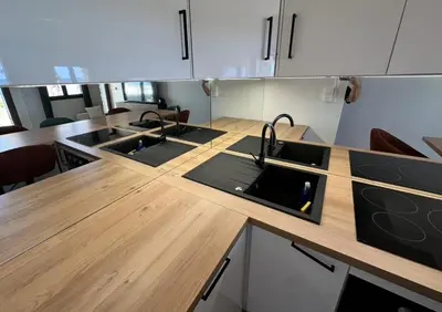 a kitchen with three sinks and a wooden counter top at Casa Amore Pinarello in Zonza