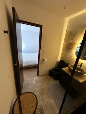 a bathroom with a door leading to a bedroom at Casa Amore Pinarello in Zonza