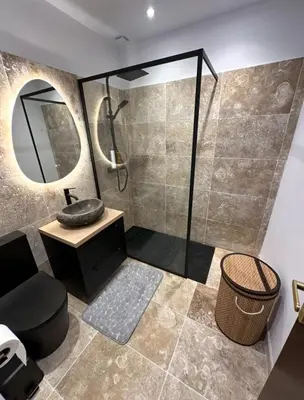 a bathroom with a shower with a sink and a mirror at Casa Amore Pinarello in Zonza