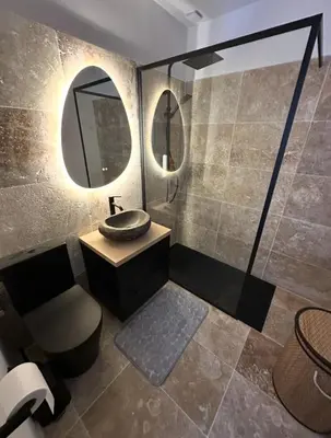 a bathroom with a sink and a mirror at Casa Amore Pinarello in Zonza
