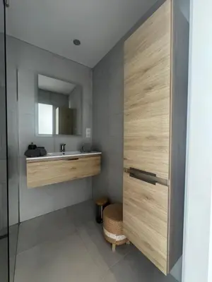 a bathroom with a sink and a mirror at Villa Domaine U Murtonu in Porto-Vecchio