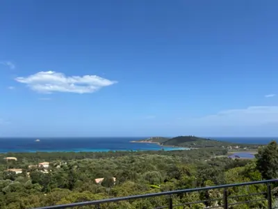 a view of the ocean from a balcony at Villa Pinarello vue panoramique mer piscine privée chauffée, plage à 900m in Zonza