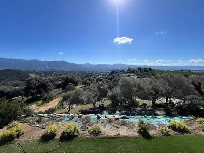 a view of a river in a field with trees at Bas de villa aux portes d'Ajaccio in Alata