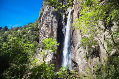a waterfall on the side of a mountain at Charmante maisonette in Porto-Vecchio