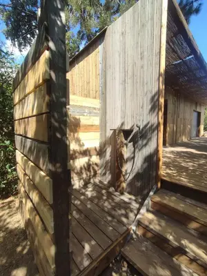 a wooden fence with a gate on the side of it at Charmante maisonette in Porto-Vecchio