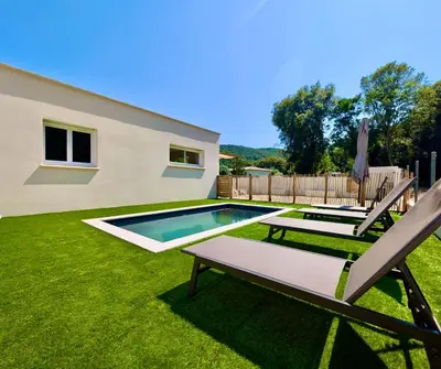 a backyard with a swimming pool and two lawn chairs at Villa Antonia in SERRA DI FIUMORBO