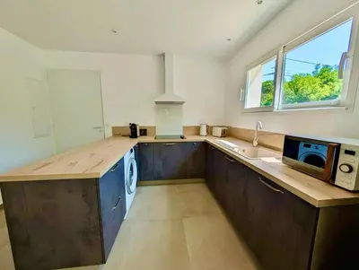 a kitchen with a counter and a sink and a microwave at Villa Antonia in SERRA DI FIUMORBO
