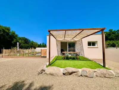 a small house with a table and grass at Villa Antonia in SERRA DI FIUMORBO