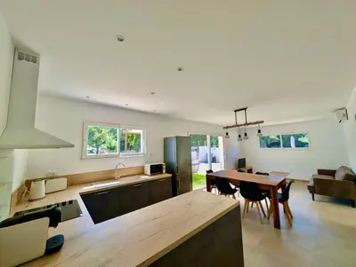 a kitchen with a wooden table and a dining room at Villa Antonia in SERRA DI FIUMORBO