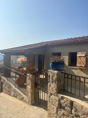 a house with a balcony with flowers on it at Casa Pitrina in Viggianello