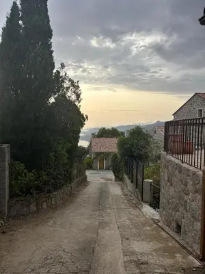 an empty road in a village with a fence at Casa Pitrina in Viggianello