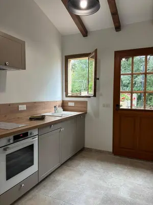 a kitchen with a stove and a sink and a window at Casa Pitrina in Viggianello