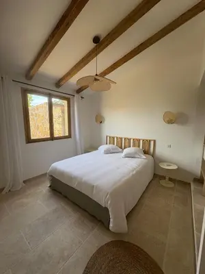 a bedroom with a large bed and a window at Casa Pitrina in Viggianello