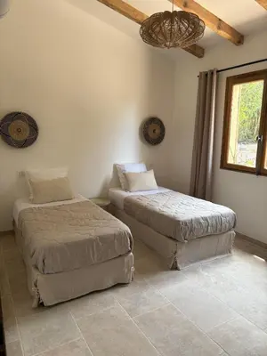 a bedroom with two beds and a ceiling at Casa Pitrina in Viggianello