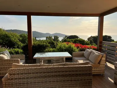 a patio with couches and a table on a deck at Costa di fiori in Coti-Chiavari