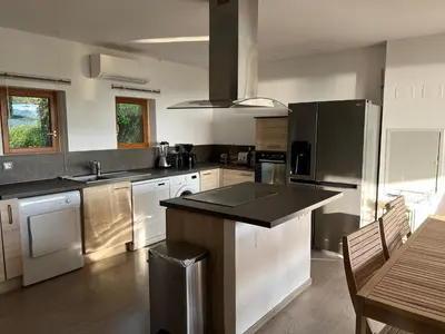 a kitchen with stainless steel appliances and a table at Costa di fiori in Coti-Chiavari