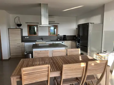 a kitchen with a table and chairs and a refrigerator at Costa di fiori in Coti-Chiavari