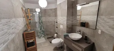 a bathroom with a toilet and a sink and a mirror at Dormir à Pinarello Corse du Sud 4 pers Vue Mer in Sainte-Lucie de Porto-Vecchio