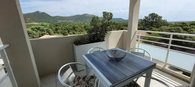 a table and chairs on a balcony with a view at Dormir à Pinarello Corse du Sud 4 pers Vue Mer in Sainte-Lucie de Porto-Vecchio