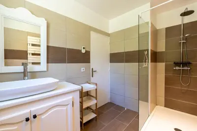 a bathroom with a sink and a shower at U Tadu - Maison de vacances en pierre avec vue et nature en Corse du Sud in Monacia-dʼAullène