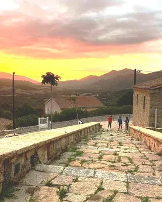 a group of people walking down a stone road at Très joli gîte T3, 55m2 climatisé région Propriano 5 personnes in Compoli