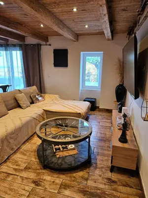 a living room with a couch and a table at Maison au coeur du maquis in Porto-Vecchio