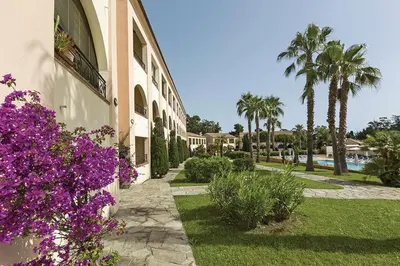 a building with purple flowers on the side of it at Cozy 2-room beachfront Résidence Sognu Di Mare Casa Serenita in Linguizzetta