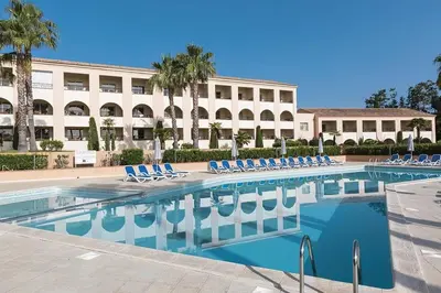 a swimming pool with lounge chairs in front of a building at Cozy 2-room beachfront Résidence Sognu Di Mare Casa Serenita in Linguizzetta